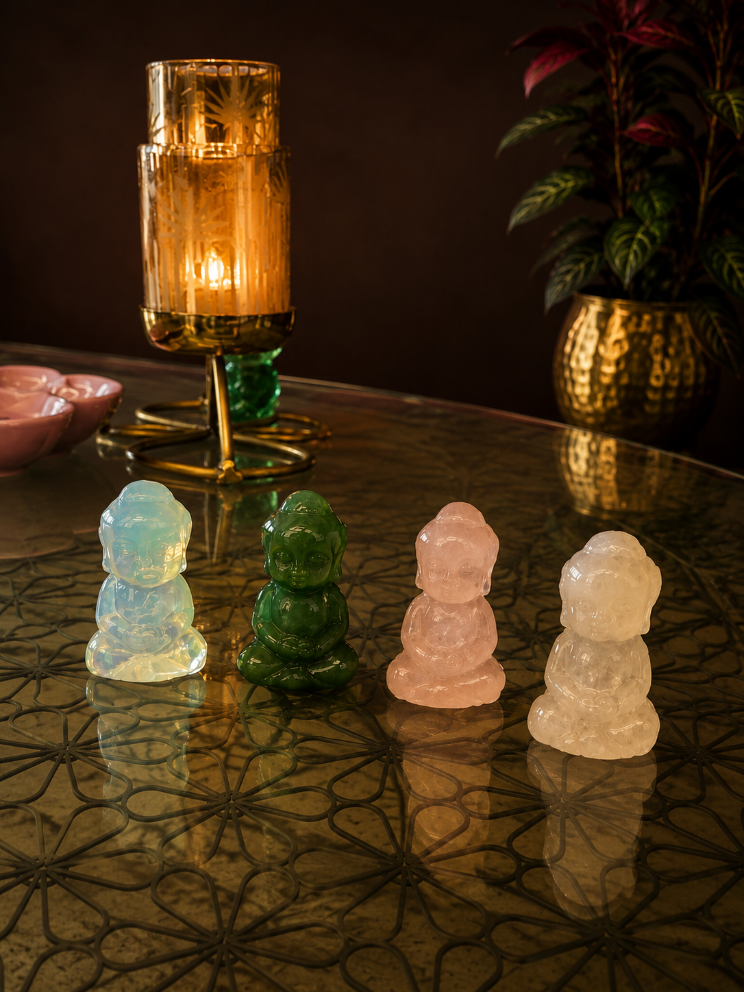 1 inch full body Buddha crystal figurines in different healing stones displayed on a decorative table